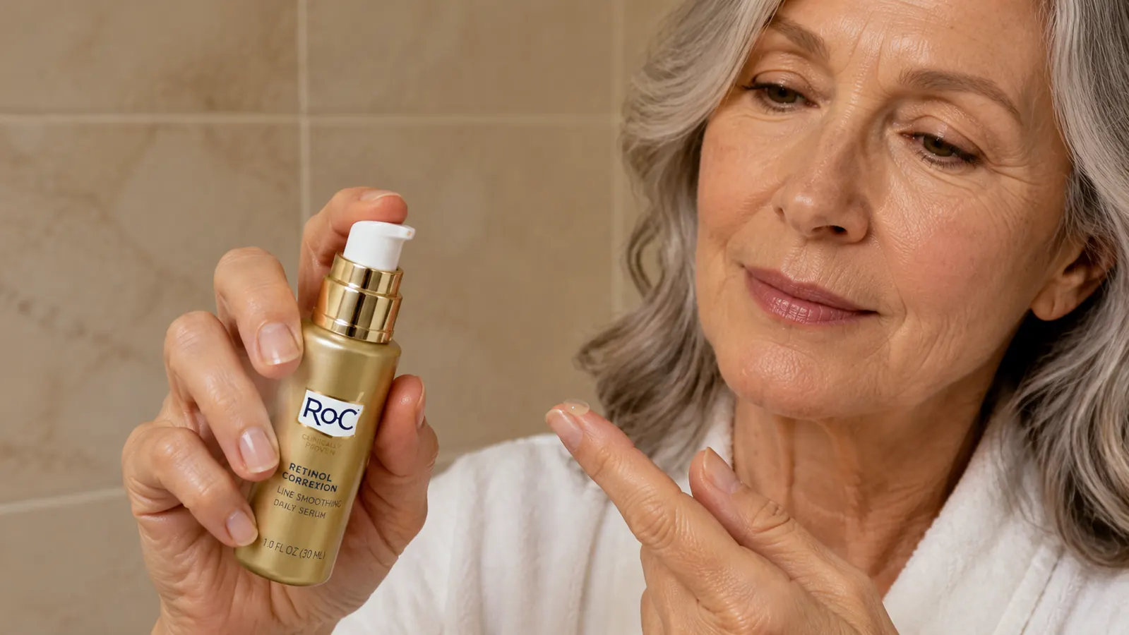 RoC Retinol Correxion serum bottle held in a woman's hand near a bathroom sink